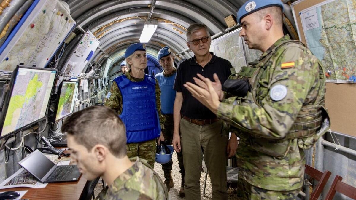 Jean-Pierre Lacroix converses with peacekeepers in a technical environment.